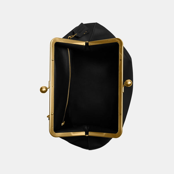 حقيبة كبيرة بإطار معدني وقفل متعاكس