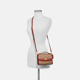 حقيبة "كيب KIP" الكروس بودي من القماش الذي يحمل نقشة ماركة كوتش و مزودة بقفل دوار